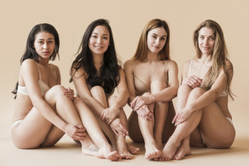 Group of attractive young women in underwear sitting in studio Free Photo