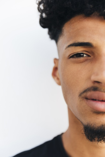 Half face of black young man Free Photo