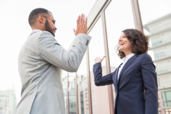 Business colleagues giving high five Free Photo