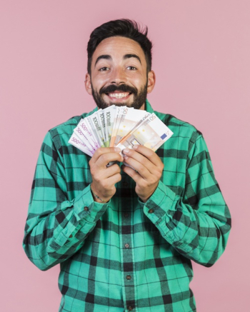 Medium shot happy guy holding money Free Photo