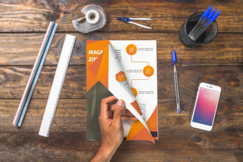 Magazine and smartphone mockup on wooden table with pens and rulers Free Psd