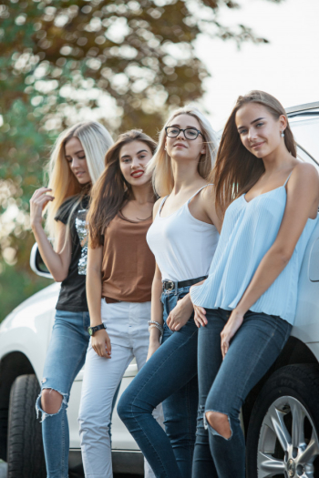 The young women standing near the car Free Photo