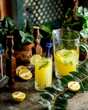 Homemade lemonade with lime mint lemonnd straws in a glass Free Photo