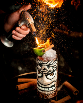 Flamed cocktail with ice and fruits Free Photo