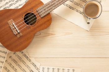 Top view acoustic guitar with wooden background Free Photo