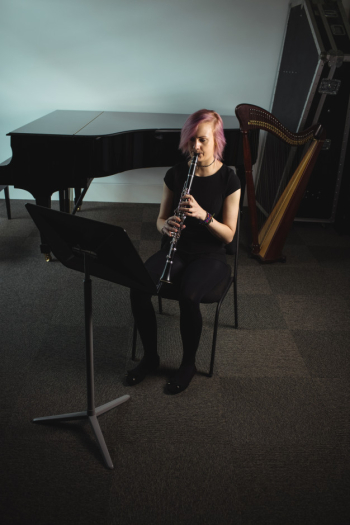 Woman playing a clarinet in music school Free Photo
