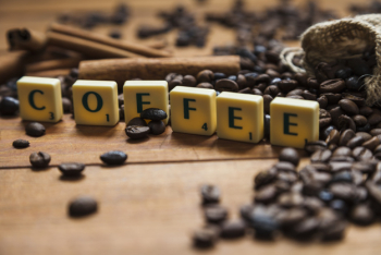 Close-up coffee writing near beans