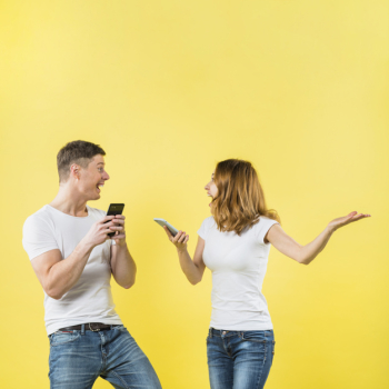 Excited young couple holding mobile phone in hand shouting with joy