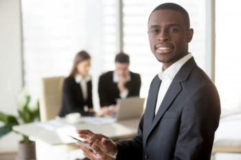 Black businessman using digital tablet on meeting