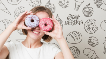 Smiling woman looking through donuts Free Psd