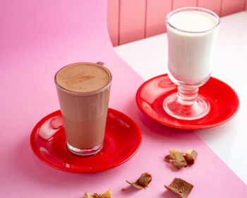 Hot chocolate with steamed milk and chocolate on table Free Photo