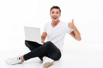 Portrait of a happy excited man holding laptop computer Free Photo