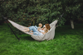 Mother with children having fun in a hammock. mom and kids in a hammock.
