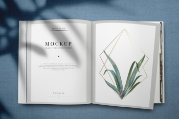 Magazine mockup with leaves and golden frame Free Psd