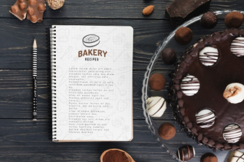 Notebook mockup with delicious pastry Free Psd