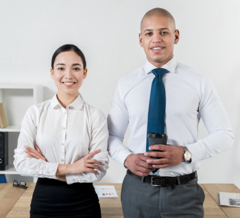Portrait of a smiling young businessman holding disposable coffee cup in hand standing with businesswoman