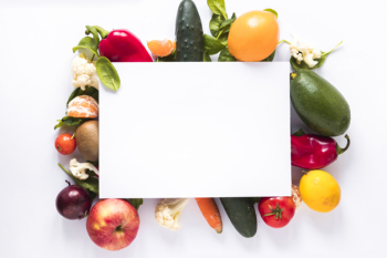 Top view of blank paper over fresh vegetables and fruits on white background