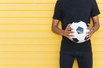 Young black man with soccer ball Free Photo