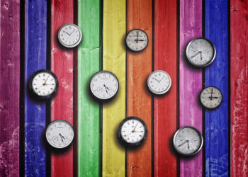  Clocks on colorful wood background - Time concept 