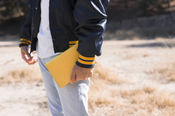 Young male with yellow book in hand Free Photo