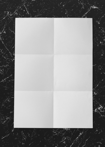 White folded paper on marble mockup Free Psd
