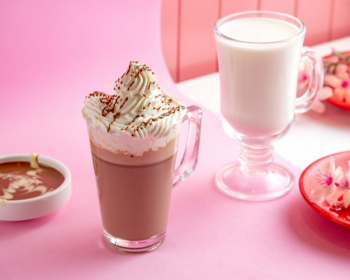 Hot chocolate with whipped cream milk and chocolate on table Free Photo