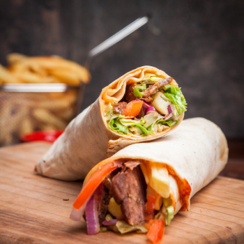Side view shawarma with fried potatoes in board cookware Free Photo