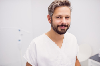 Portrait of dentist standing in clinic Free Photo