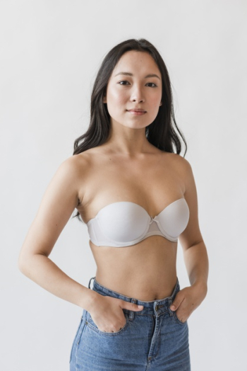 Asian female in bra with hands in pockets Free Photo