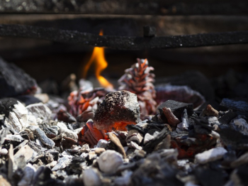 Orange smoldering coals and low flame in barbecue Free Photo