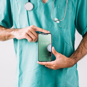 Doctor showing smartphone mockup Free Psd