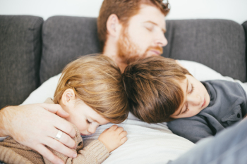 Dad snoozing with cute sons on sofa Free Photo