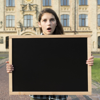 Medium shot surprised highschool girl holding blackboard Free Photo