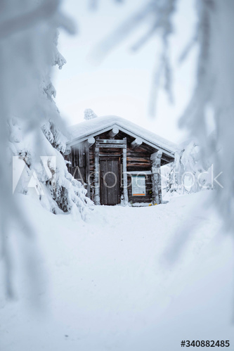 Wooden cabin in a snowy forest in Finland