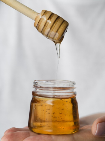 Honey dripping from dipper Free Photo
