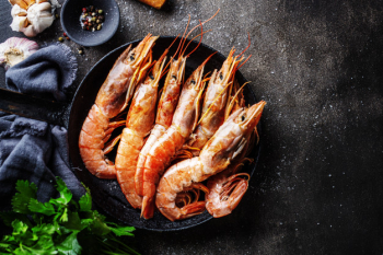 Raw giant shrimps on dark table Free Photo