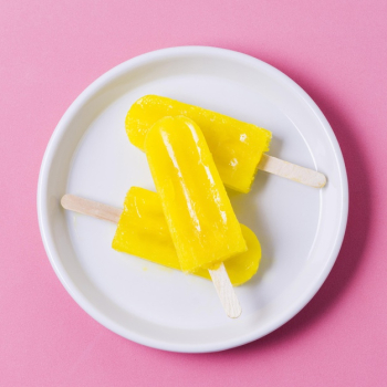 Flavored ice creams on stick on plate Free Photo
