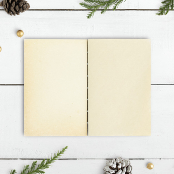 Blank notebook on a christmas table mockup Free Psd