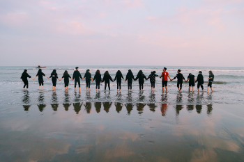 Team Holding Their Hands On Seashore Â· Free Stock Photo