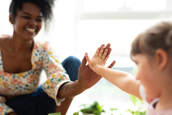 Multiracial family at home doing a high five  | Free stock photo | High Resolution image
