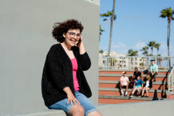 Teen girl on the phone, away from friends | Free stock photo | High Resolution image