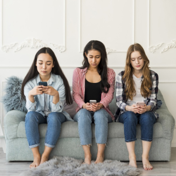 Multiethnic group of teenagers sitting using phones Free Photo