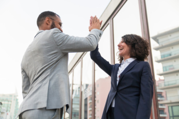 Cheerful business colleagues giving high five Free Photo