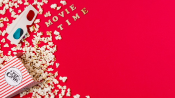 Movie time text with 3d glasses and spilled popcorn on red background Free Photo