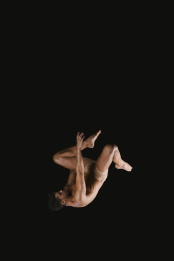 Gymnast doing somersault exercise in air Free Photo
