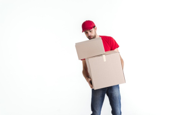 Delivery man leaning over the parcel post boxes Free Photo