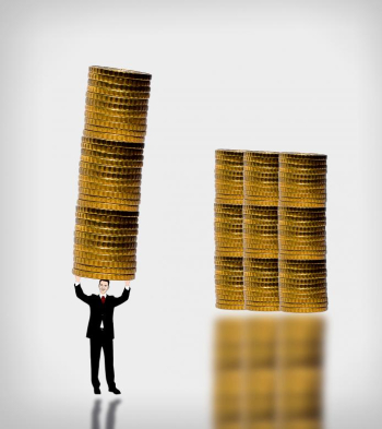Businessman carrying a gold coin stack