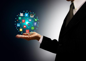 Businessman holding hologram with social media network icons