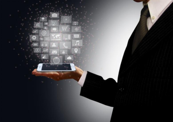 Businessman holding a smartphone with information technology holograph