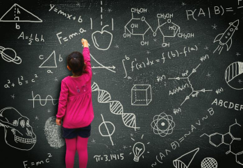 Little girl writing on blackboard